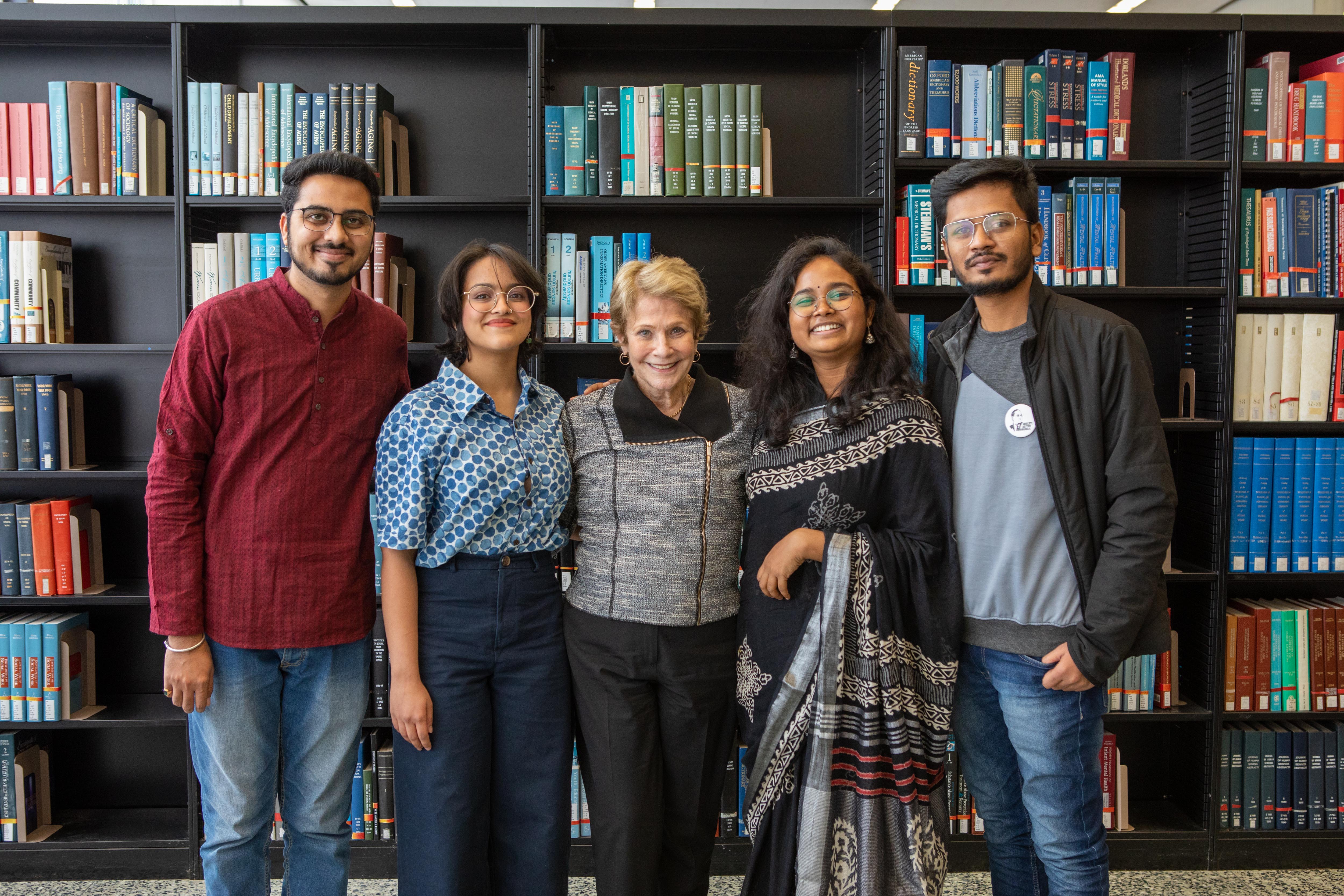 Group of people standing in front of books