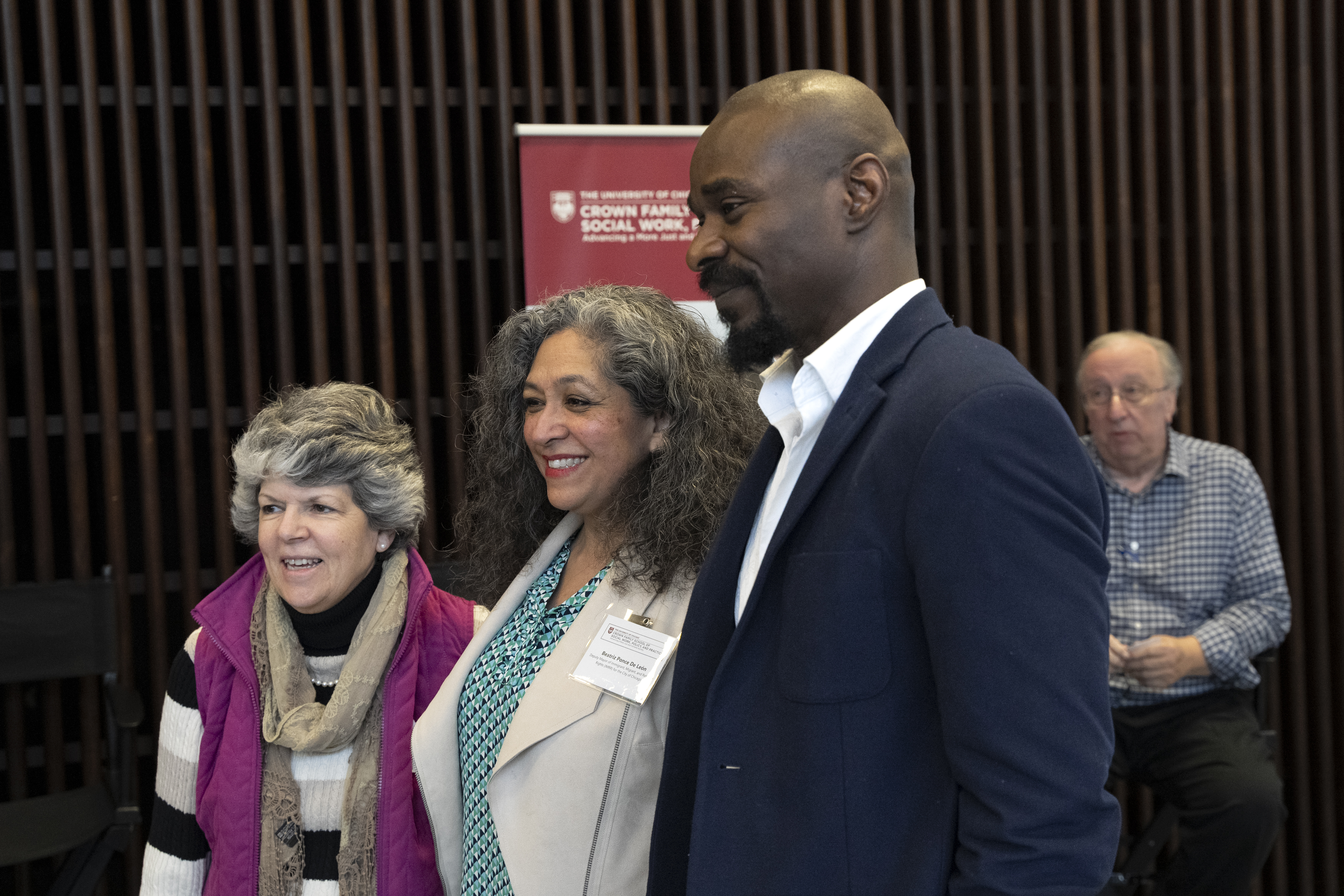 three people standing together smiling