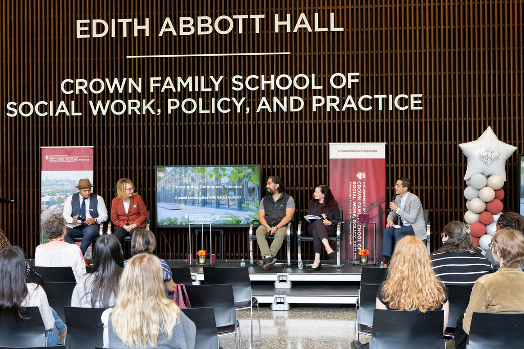 a panel sitting under a sign that says Crown Family School of Social Work