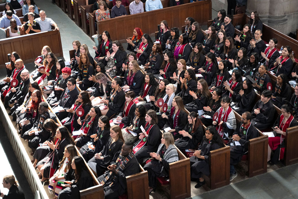 A photo taken from above of graduates sitting in Rockefeller Chapel. 