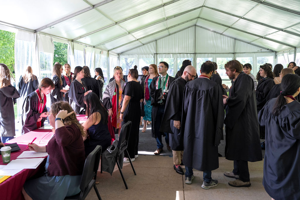 Students sign in before hooding ceremony