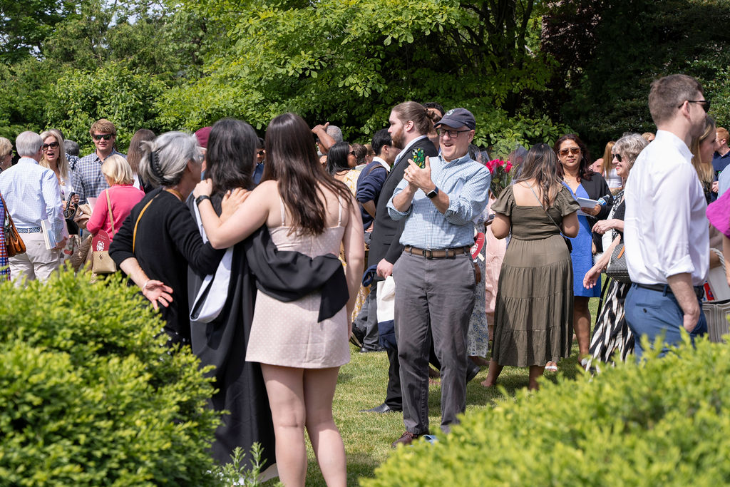 Family and friends gather on Rockefeller Chapel yard waiting for graduates and taking photos 