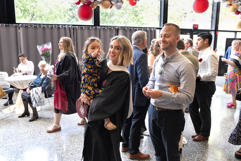 Reception following hooding ceremony gets underway as attendees get drinks and food 