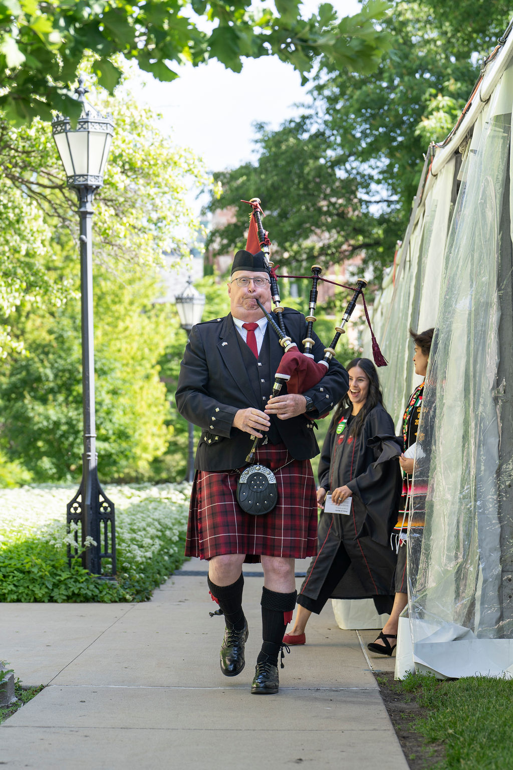 Bagpiper begins marching for the hooding ceremony