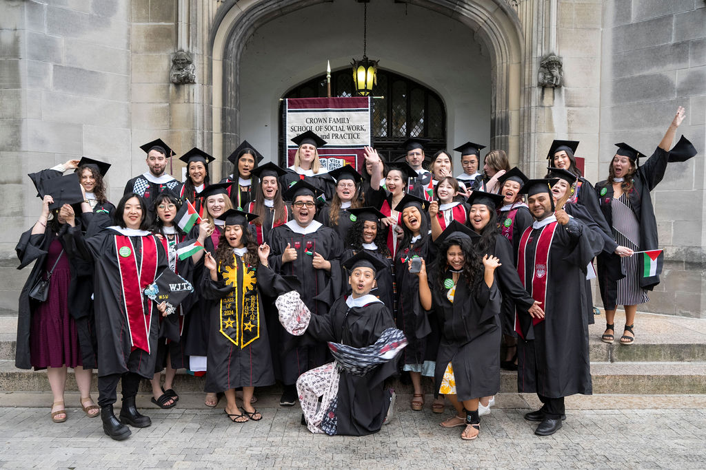 A large group of graduate gather outside to celebrate convocation