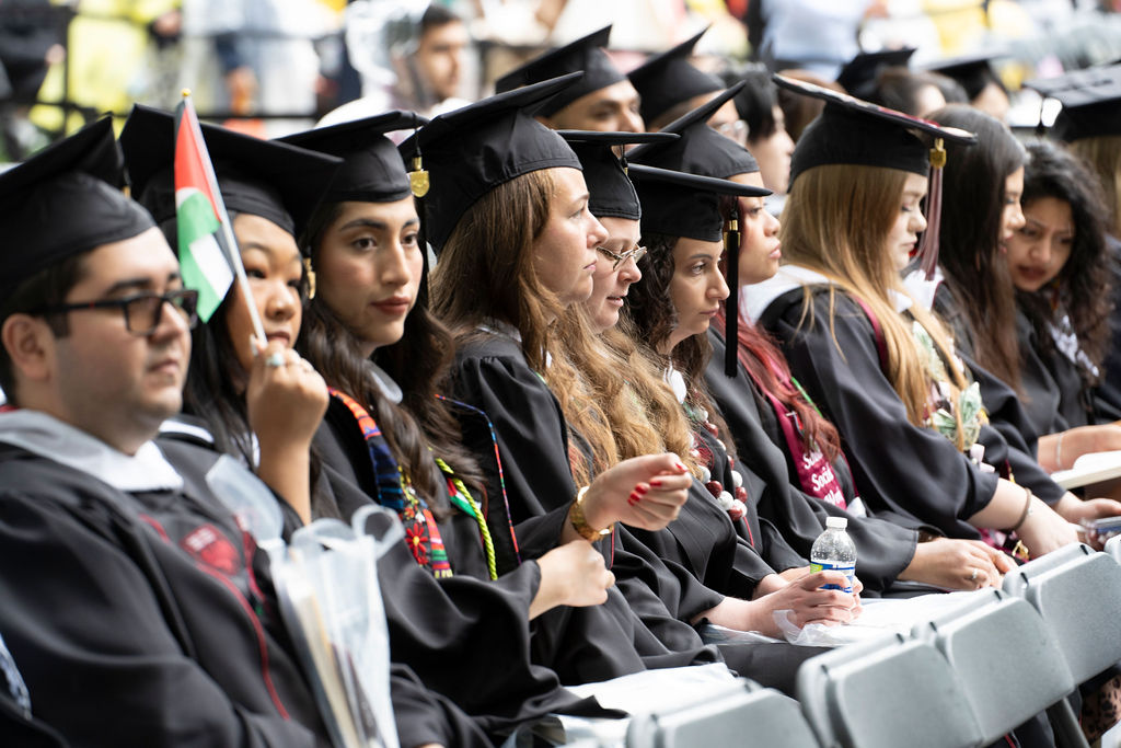 A row of graduates in academic regalia at convocation