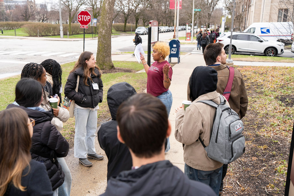 A group of students walking outside with a tour guide