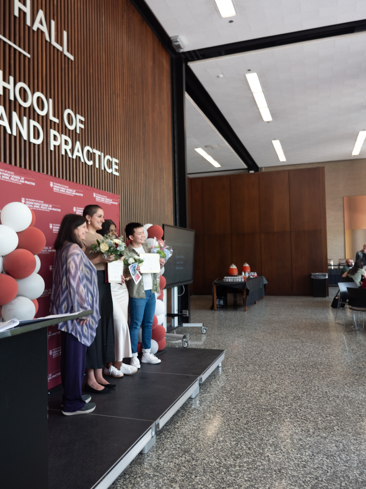 Student awardees on stage together facing the audience and smiling