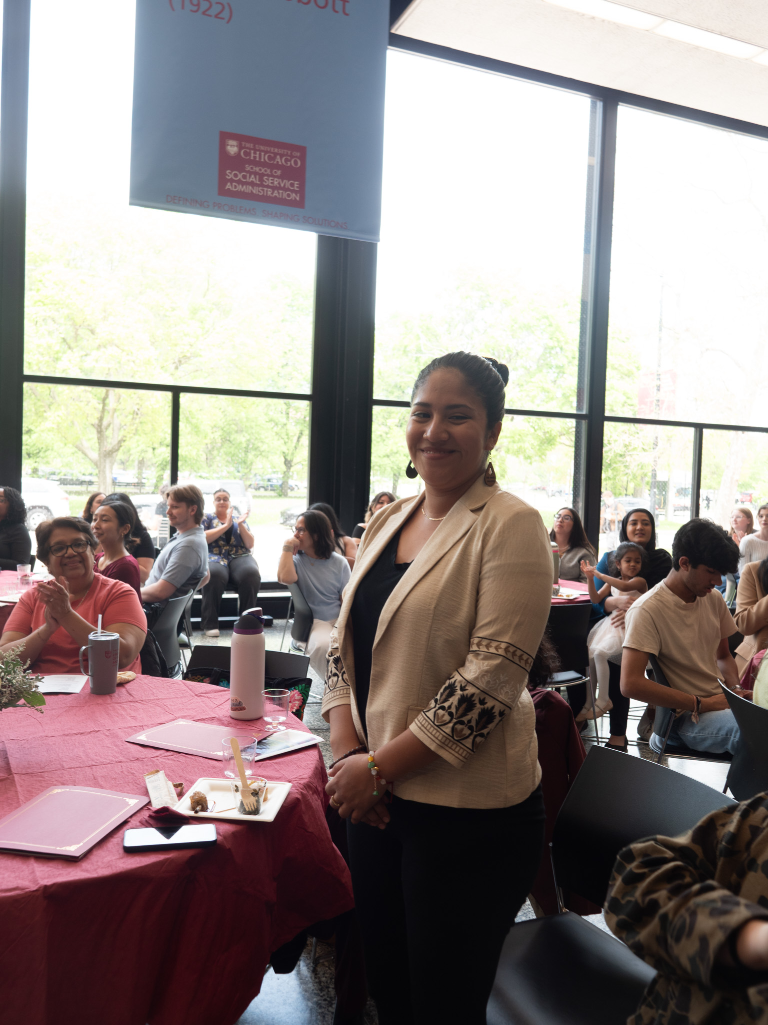 student standing and receiving recognition 