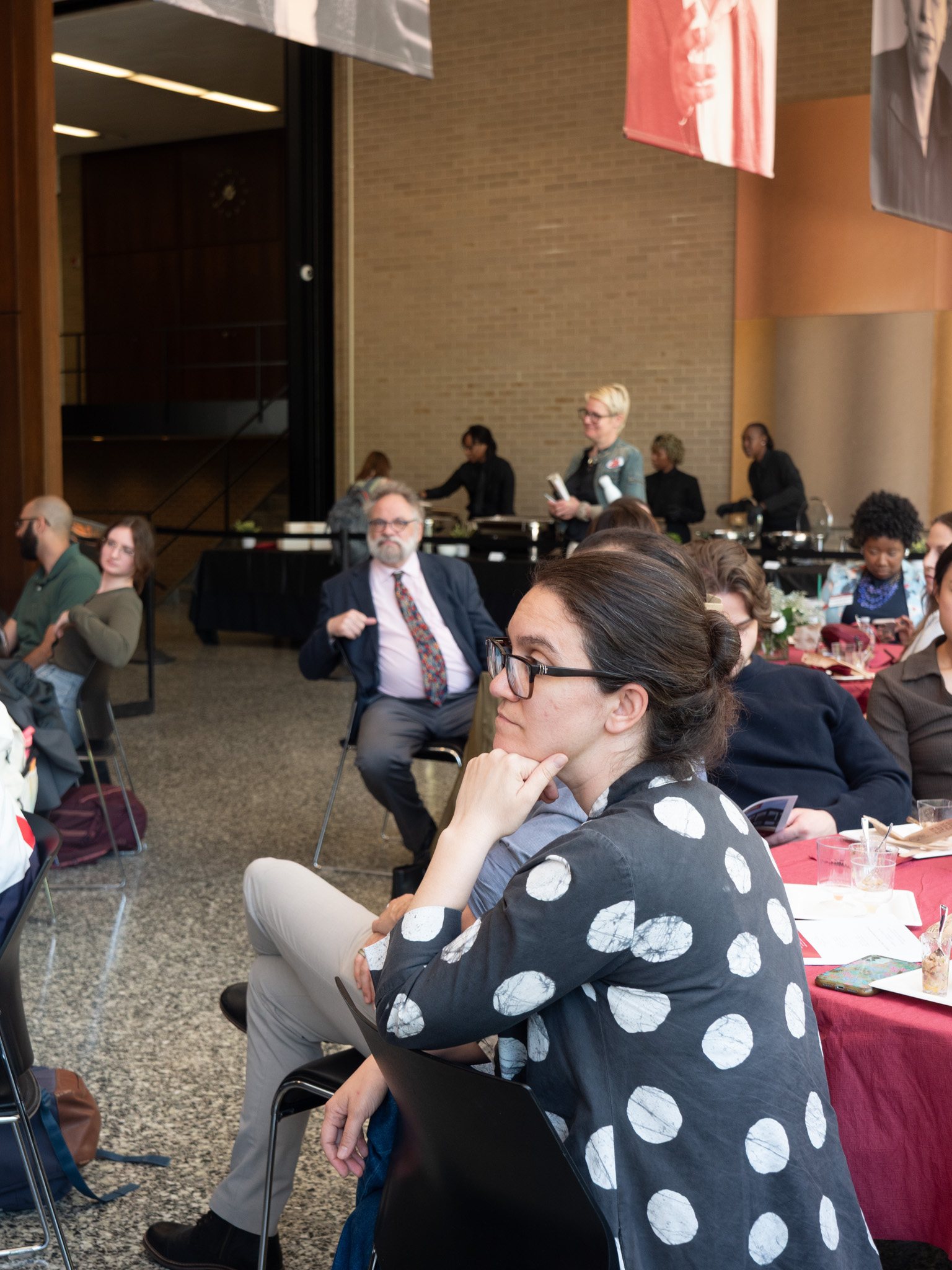 audience member attentively listening to speaker 