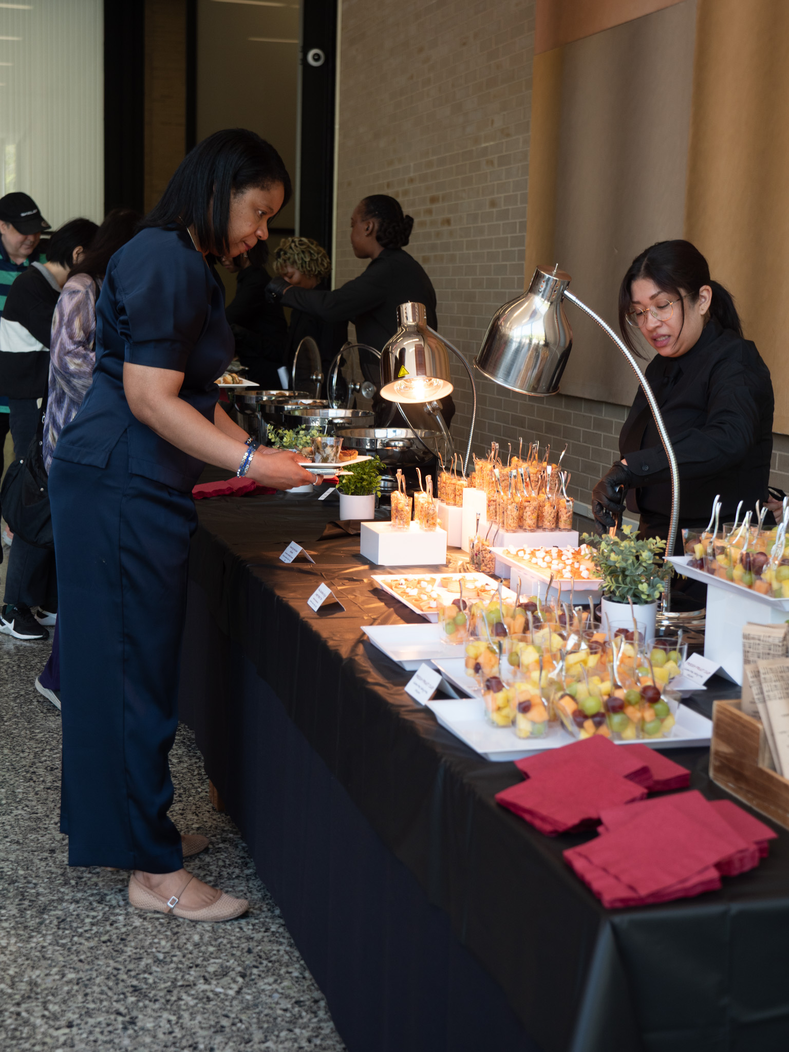 Line of people at a table getting food