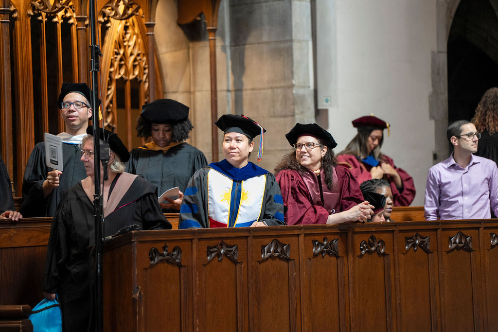image of a group of staff in regalia looking on in pride