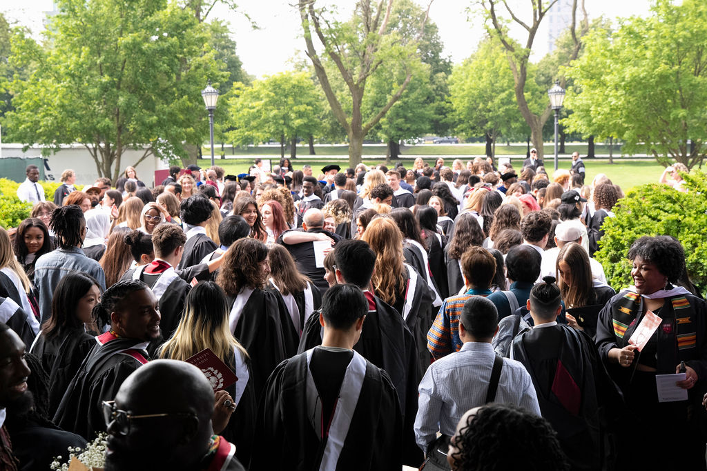 image of a crowd of graduates all processing and gathering outside of the chapel