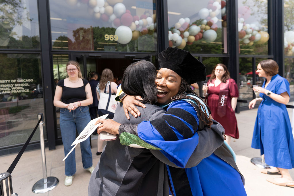 Two people hugging outside reception
