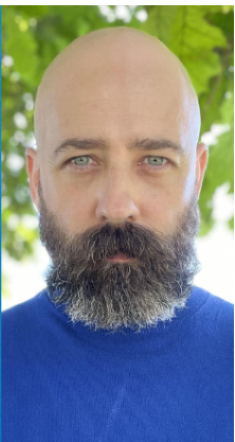 Man with beard in blue shirt