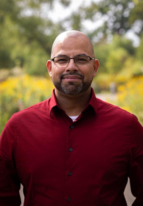 Male in a red button up shirt with glasses