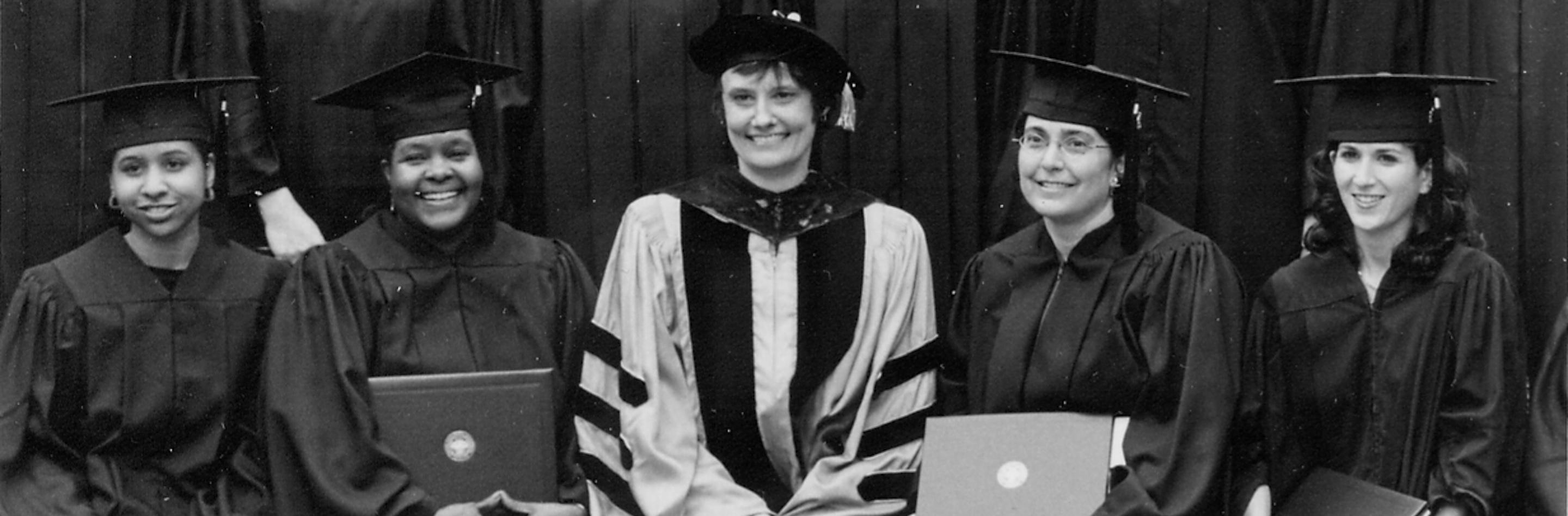 A black and white photo of a row of graduates