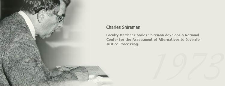 An image of Charles Shireman signing a document