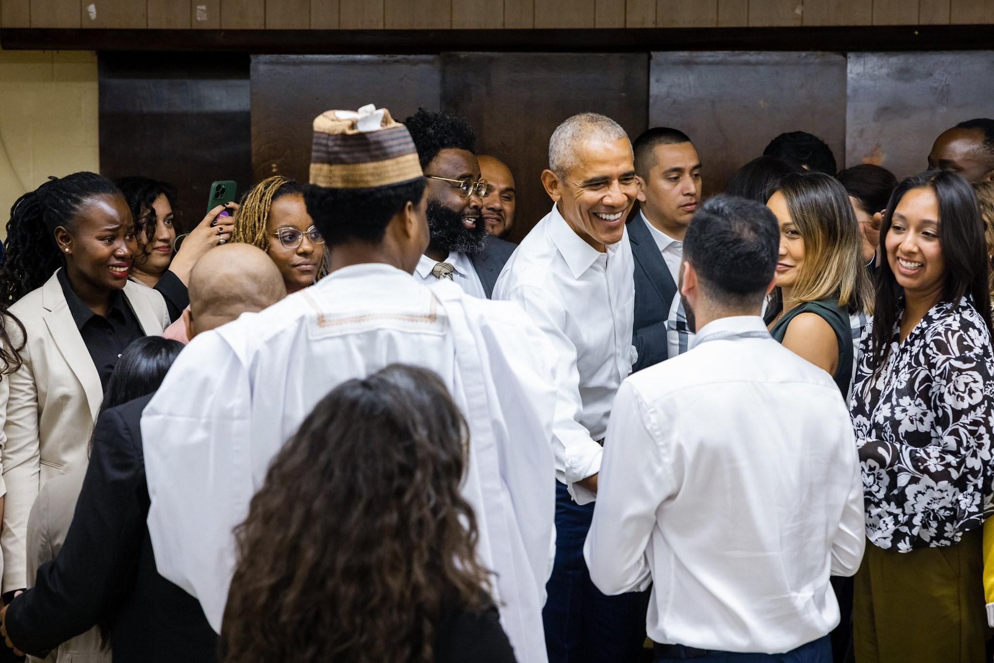 President Barack Obama greets past members of the Obama Foundation Scholars program.
