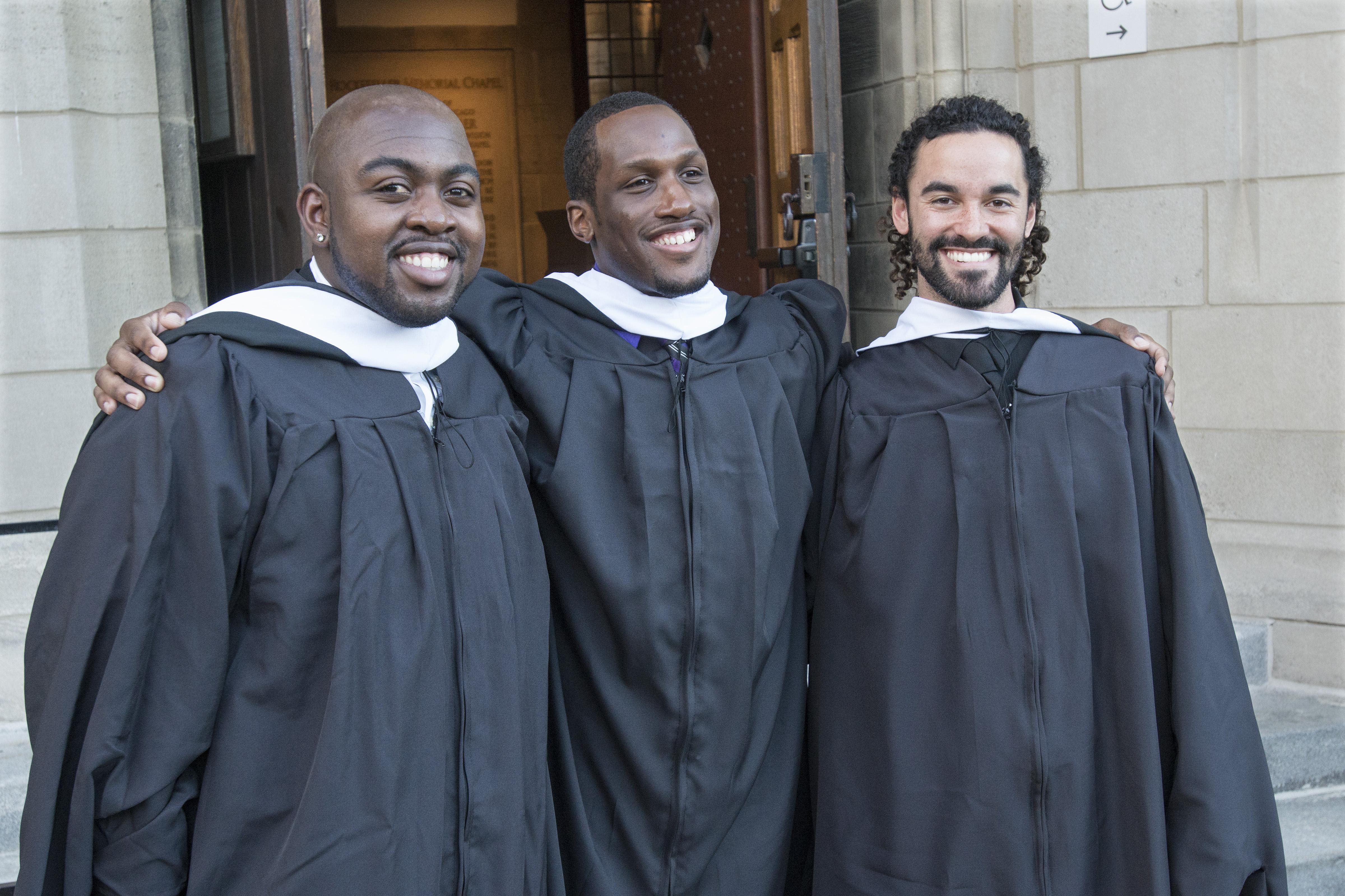 Group of men in black robes smiling