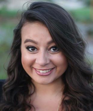 woman in black shirt with long brown hair smiling