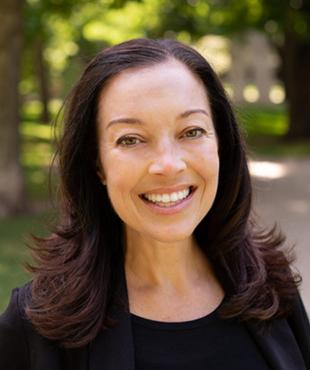 Jennifer Cutilletta wearing a black blouse pictured in an outdoor park setting