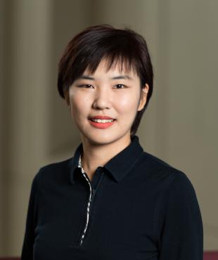 Woman in black with short hair cut smiling