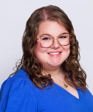 Woman wearing blue smiling for headshot
