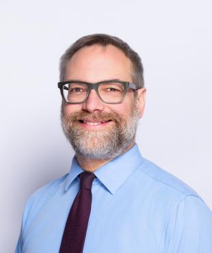 Man smiling for headshot 