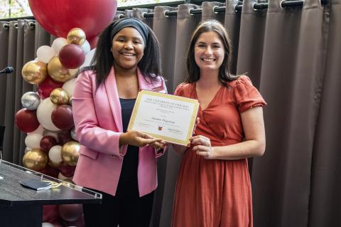 Autumn Hagstrom receives a certificate for contributing to the Advocates' Forum 2023 issue