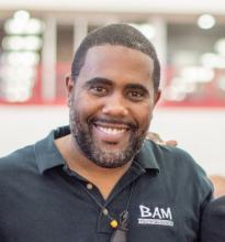 man in black shirt smiling