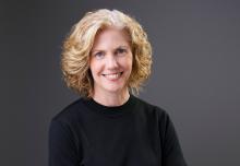 Headshot of Beth Swanson in black shirt smiling 