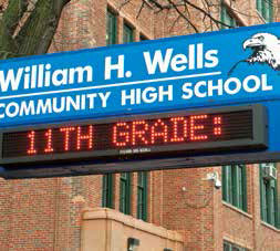 Sign that reads William H. Wells Community High School, 11th Grade: